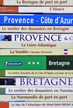 Collection of travel guides about France on a bookshelf