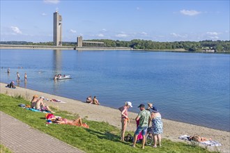 Tourists sunbathing and paddling in summer in lake of the Lacs de L'Eau d'Heure