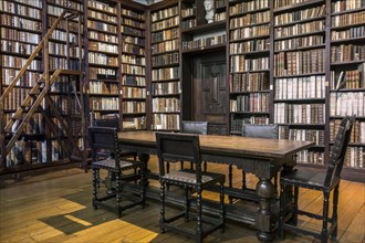 Bookshelves with old books in the Small Library at the Plantin-Moretus Museum
