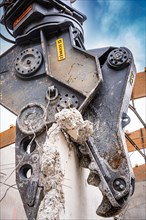 Spreader on Liebherr crawler excavator during recycling on demolition site