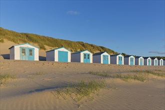 Row of blue and white beach cabins on Texel
