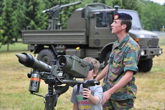 Soldier showing Mistral Air Defence Missile System to child during open day of the Belgian army at Leopoldsburg