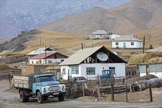 Old truck and houses in the small rural village Sary-Tash in the Alay Valley of Osh Region
