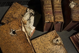 Old books damaged during World War Two bombardment displayed at the Memorial de Caen