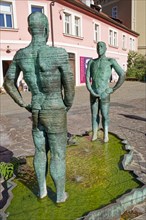Two male figures peeing
