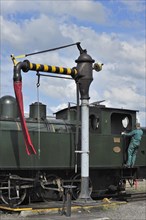 Engine driver filling boiler of steam train from water crane at the depot of the Chemin de Fer a Vapeur des Trois Vallees at Mariembourg