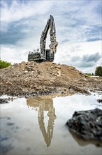 Black Liebherr crawler excavator recycling on demolition site