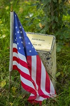 American flag at commemoration stone for fallen soldier at Bois de la Paix