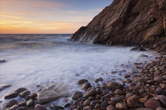 Rocks on the beach and cliffs at sunset along the rocky coast at Josefinelust