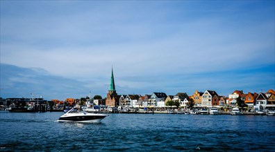 Trave with front rows of houses in Travemuende at the harbour. Hanseatic City of Luebeck