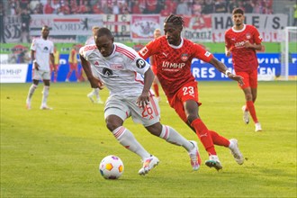Jerome ROUSSILLION Union Berlin left in a duel with Omar TRAORE 1. FC Heidenheim