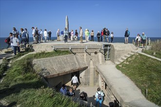 Tourists visiting Second World War Two monument at the Pointe du Hoc cliff overlooking the English Channel
