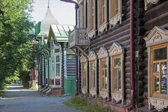 Street with traditional ornate wooden houses in the city Tomsk