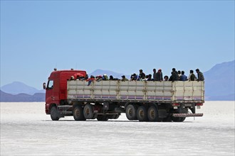 Truck with school children on the salt flat Salar de Uyuni