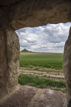 View over the Waterloo battlefield and the Lion Hill seen through loophole in the garden wall of the Chateau d'Hougoumont