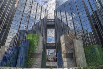 Art object the mosaic by artist Michel Deverne in front of office skyscrapers