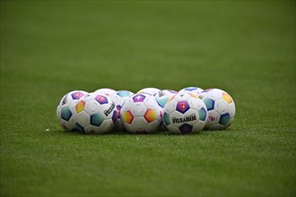 Adidas match balls Derbystar lie on grass