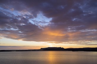 Rain clouds at sunset over lake Prestholalon
