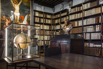 Bookshelves with old books in the 17th century Great Library at the Plantin-Moretus Museum
