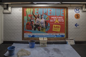 Freshly hoisted large poster in a metro station