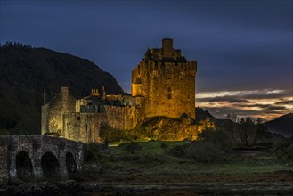 Illuminated Eilean Donan Castle at night in Loch Duich