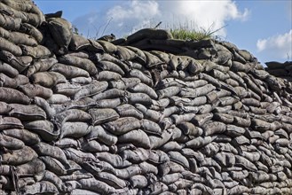 Wall of stacked sandbags in WWI trench used as defence in First World War One warfare