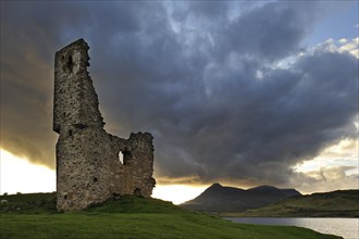 The 16th century Ardvreck Castle ruins at Loch Assynt in the Highlands at sunset