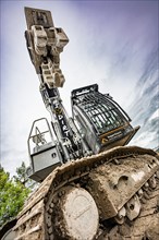 Black Liebherr crawler excavator recycling on demolition site