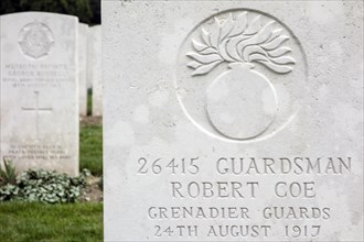 Grenadier guards regimental badge on headstone at Cemetery of the Commonwealth War Graves Commission for First World War One British soldiers