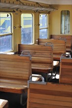 Old passenger carriage with wooden benches at the depot of the Chemin de Fer a Vapeur des Trois Vallees at Mariembourg
