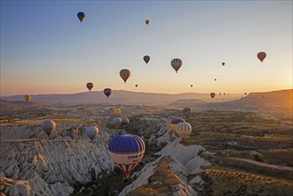 Hot air balloons flying over Cappadocia at sunrise