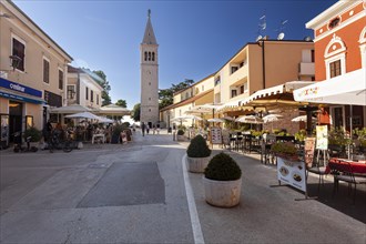 Belltower and terraces of restaurants in the historic town centre of Novigrad