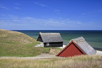 Fishing huts in the dunes along the Baltic Sea at Havaeng