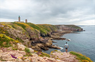 A young tourist on the coast next to the Phare Du Cap Frehel