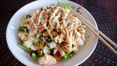 Overhead close up to a classic chicken salad with olives and crouton