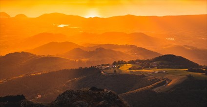 Aerial view in a gradient of orange colors in a beautiful sunset from a top of a mountain