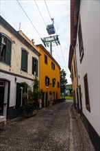 Cable car between the houses in the city of Funchal in Madeira. Portugal
