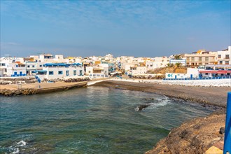 View from above of the black beach of the tourist town of El Cotillo in the north of the island of Fuerteventura