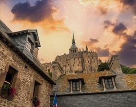 Sunset at the old wooden dwellings at the famous Mont Saint-Michel Abbey in the Manche department
