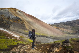A young woman on the red mountain of the 54 km trek from Landmannalaugar