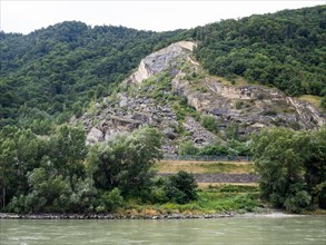 View over the Danube to a rocky slope and wooded area
