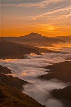 Sea of clouds under Mount Larrun in a beautiful sunrise. Basque Country
