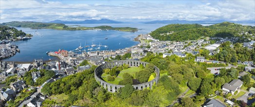 Aerial panorama of the harbour town of Oban with McCaig's Tower
