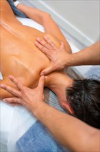 Physiotherapeutic massage to an unrecognizable woman lying on a stretcher on her back with fingers