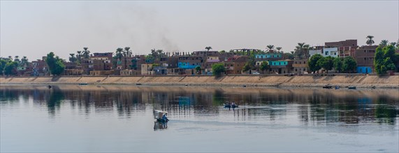 Traditional Egyptian villages on the bank of the river Nile. Views sailing on the cruise on the river Nile from Luxor to Aswer