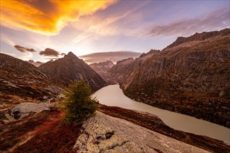 Autumn evening mood at Grimselsee in the Swiss Alps with Zinggenstock