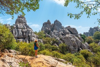 A young woman looking at the landscape of Torcal de Antequera on the green and yellow trail