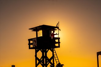 A watchman working in the summer at the Watchman's Post at sunset on the Bateles beach in Conil de la Frontera