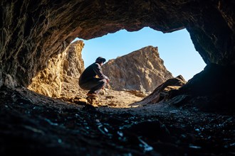 A young tourist sitting in the Almanzora caves