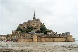 The famous Mont Saint-Michel Abbey reflected in the water at low tide